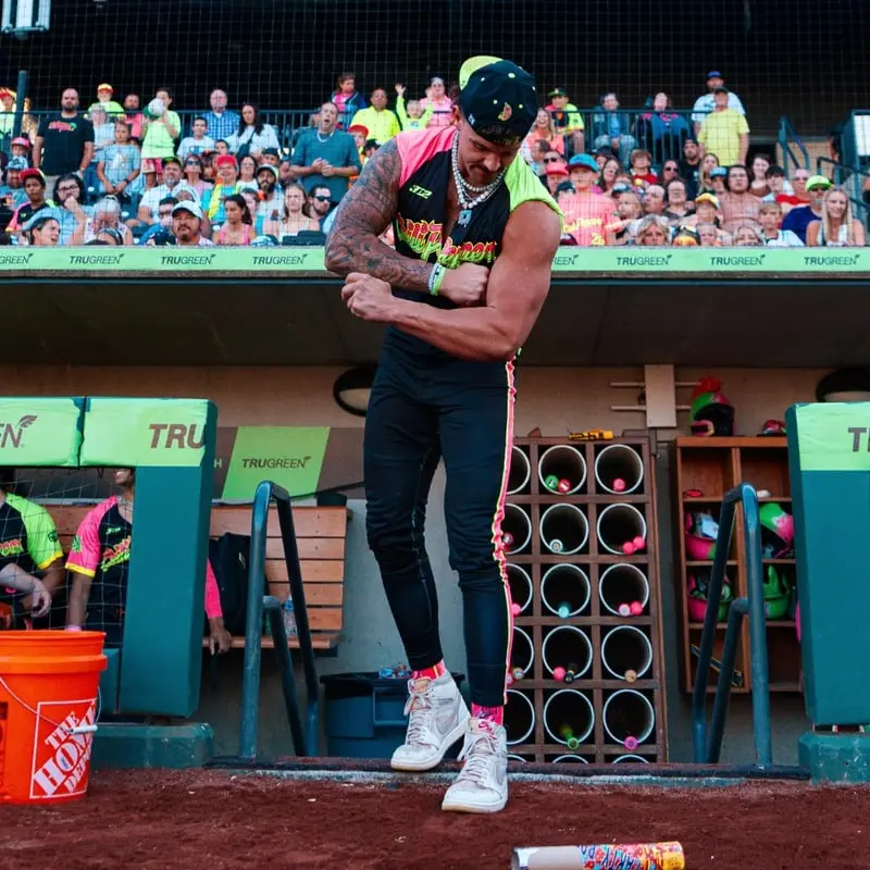 Sam Hanson flexing on the dugout steps